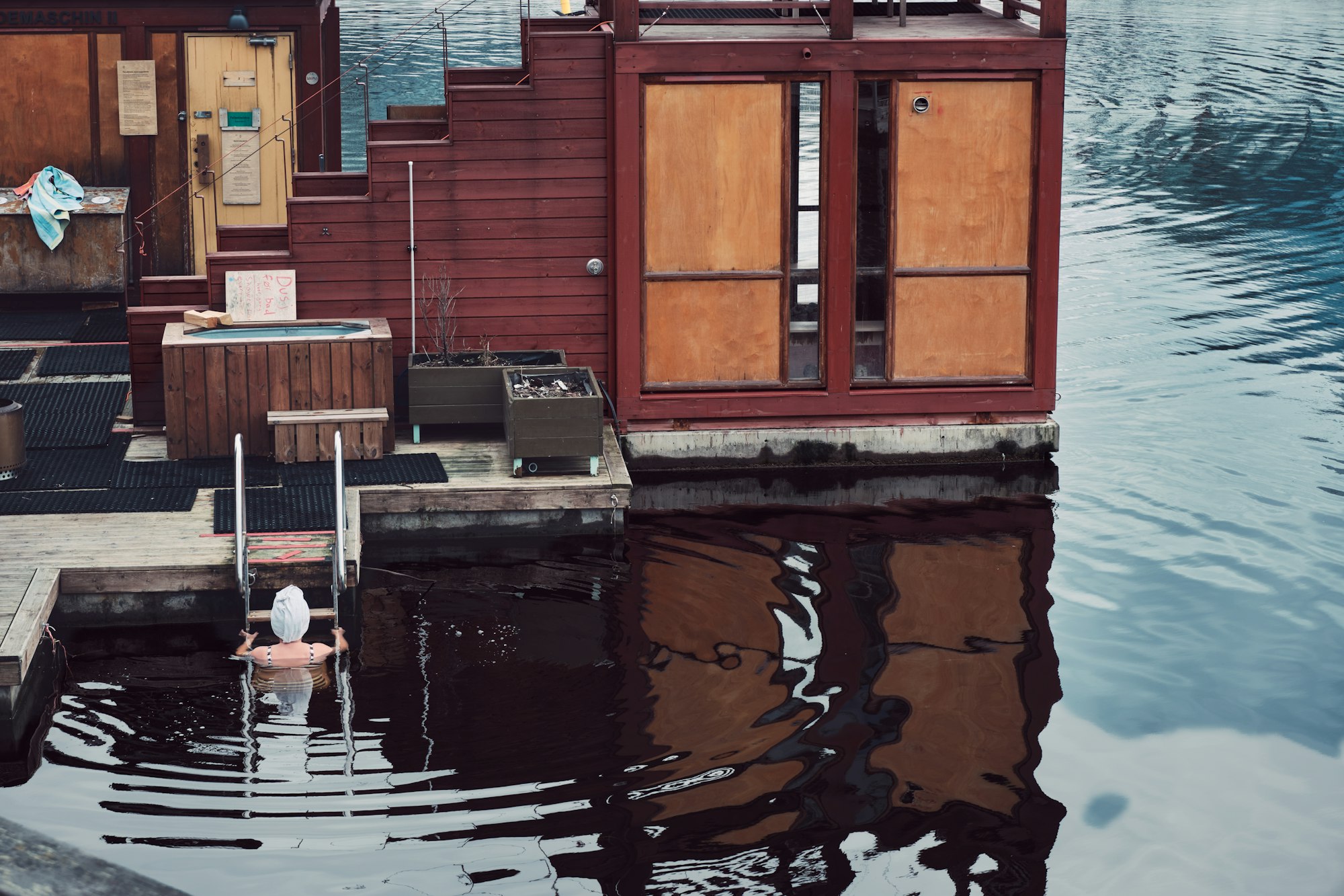 Wooden dockside cold plunge on still water