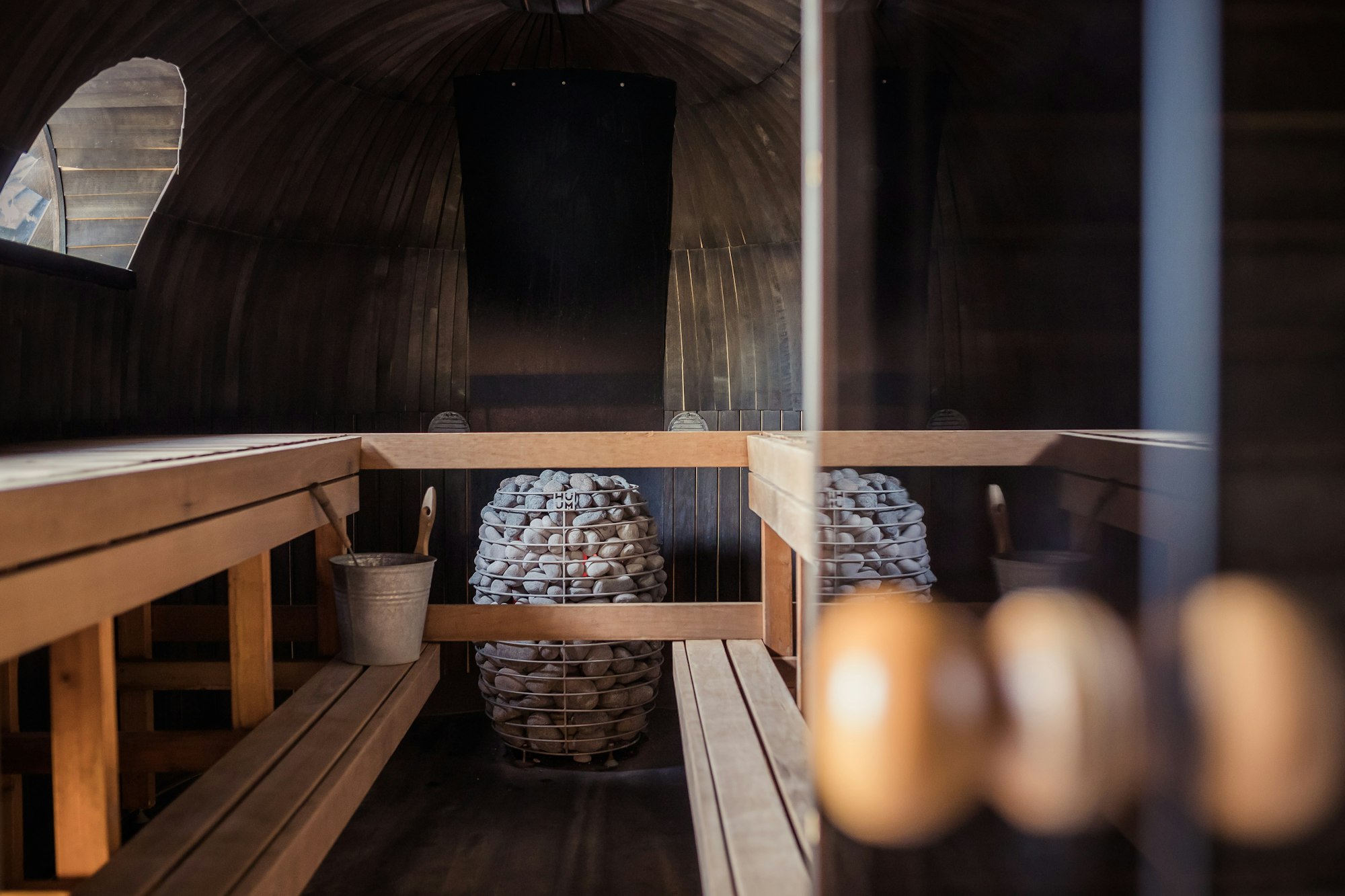 Interior of a barrel sauna with hot stones